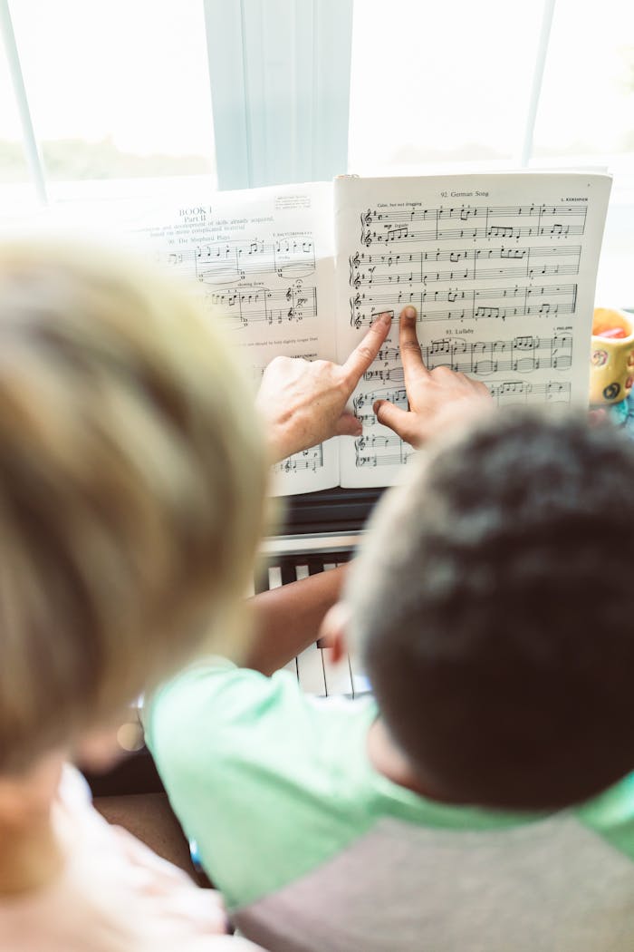 A parent guiding a child in learning piano using sheet music, highlighting a nurturing bond.
